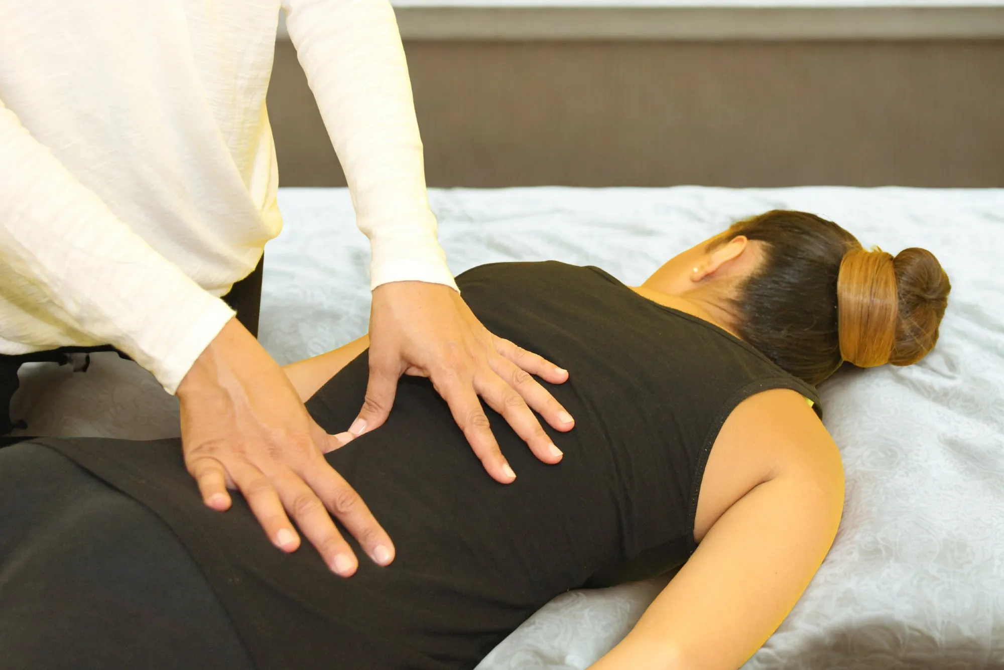 A hands-on Bowen move on the lower back