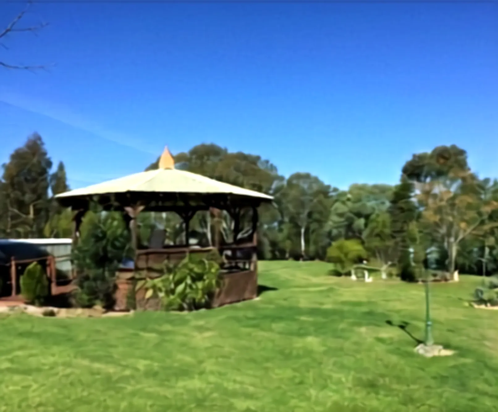 The retreat venue in Annangrove — a covered gazebo on landscaped lawns under a clear sky